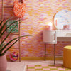Roomset of brushstroke wallpaper in vibrant pink, orange and yellow colourway 