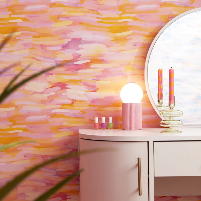Roomset close-up of brushstroke wallpaper in vibrant pink, orange and yellow colourway 