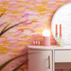 Roomset close-up of brushstroke wallpaper in vibrant pink, orange and yellow colourway 
