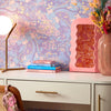 Roomset close-up of contemporay 70s, mehndi design wallpaper in cool blue and purple colourway 