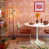 Roomset of contemporary 70s, mehndi design wallpaper in hot pink and orange colourway 