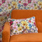 She's a Wildflower Bolster Cushion in Brights on Vintage Cream