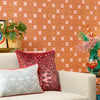 Roomset of 70s geometric wallpaper in mustard, red and subtle pink colourway 
