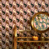 Roomset close-up of vintage geometric wallpaper in caramel, black on vintage mauve colourway 
