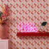 Roomset close-up of vintage geometric wallpaper in vintage pink and poison apple red colourway 