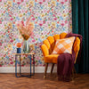 Accent chair and sidetable with flowers and wildflower meadow wallpaper design on cream background