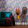 Green sofa, side table and lamp with Wildflower meadow wallpaper design on blue background